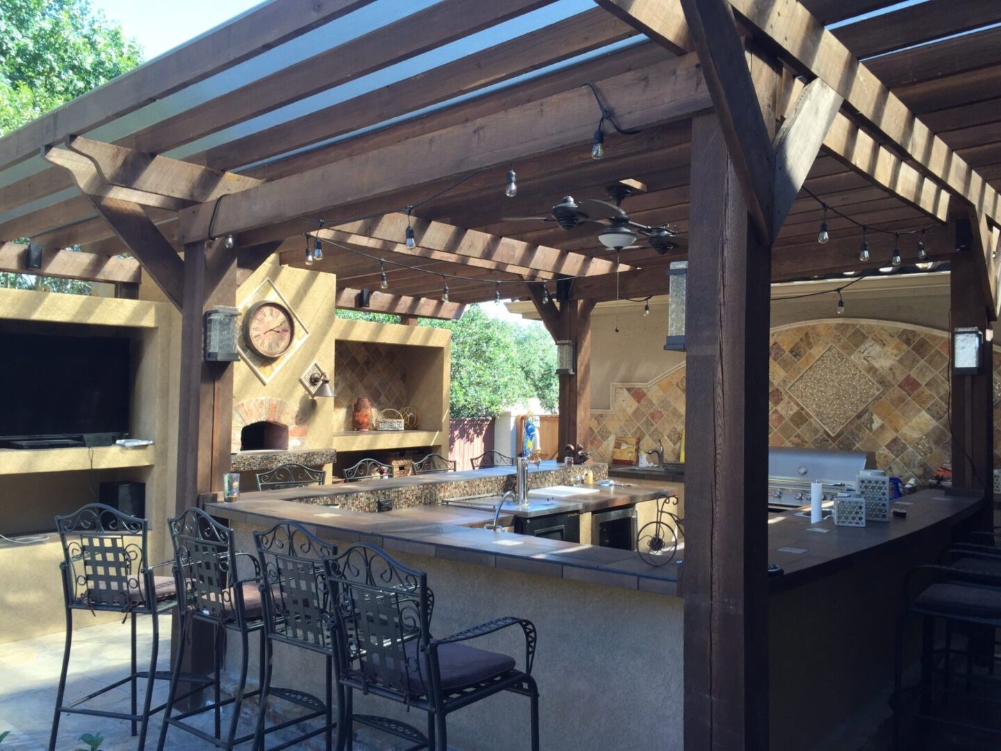 A patio with an outdoor kitchen and bar.