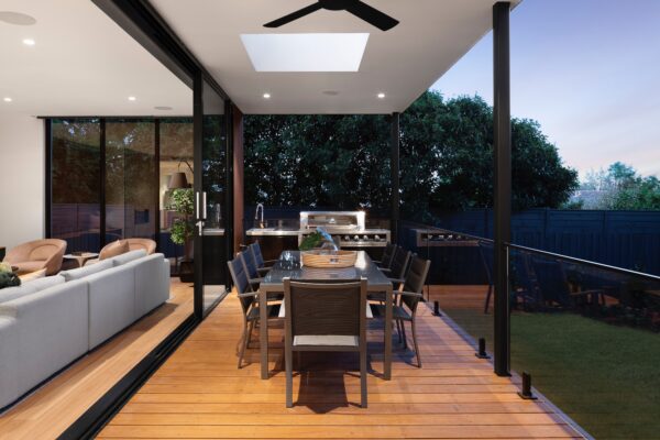 A patio with an outdoor grill and dining table.